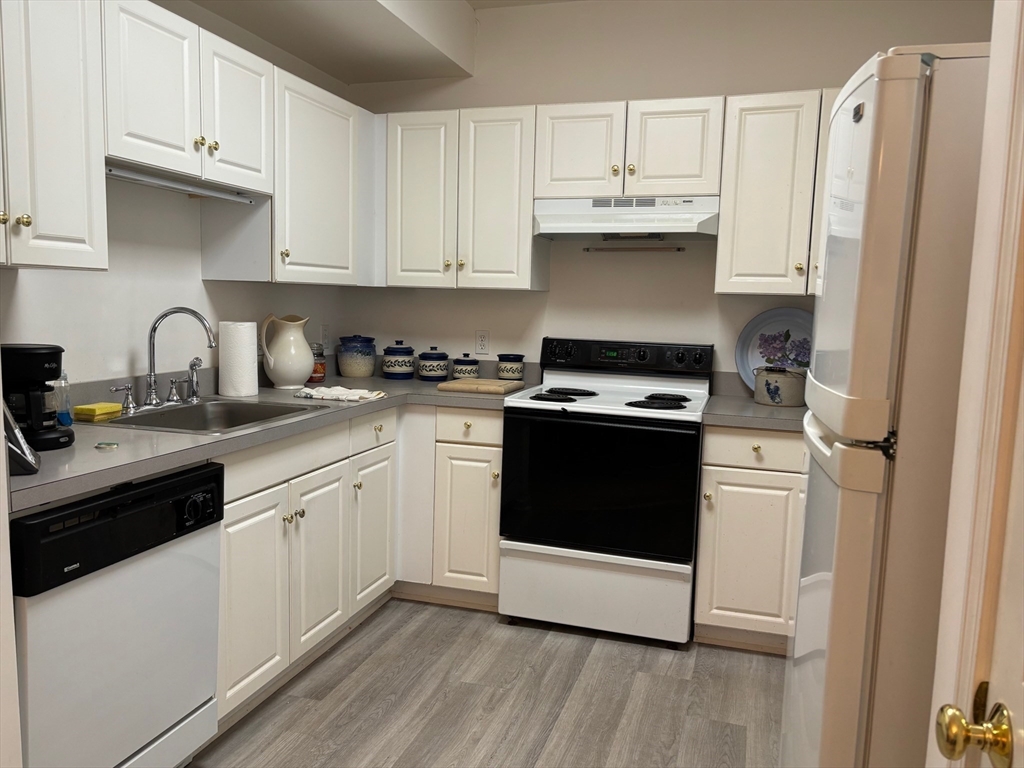 1 Riverview Boulevard, Unit 38 Methuen, MA 01844 - Photo 8 of 41 a kitchen with granite countertop white cabinets and white appliances