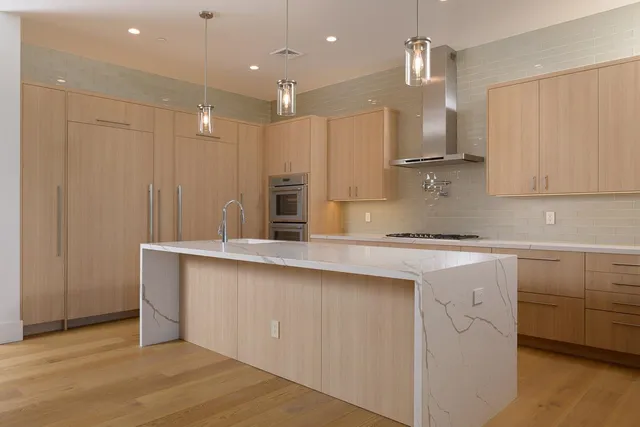 a kitchen with counter top space sink and refrigerator