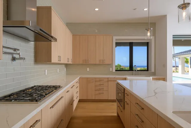 a kitchen with a sink stove top oven and cabinets