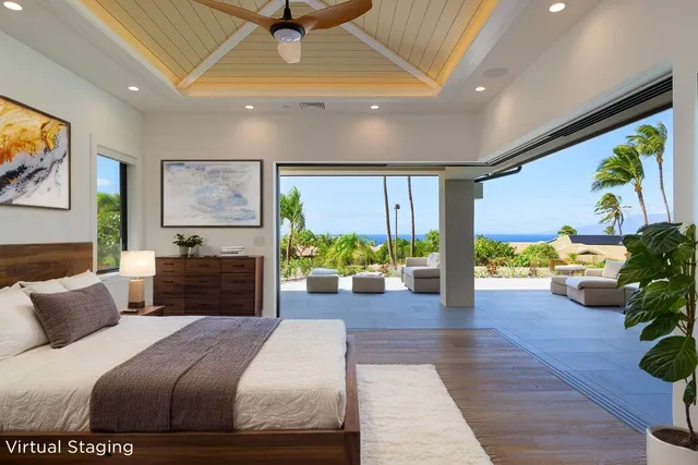 a large bedroom with a bed and large windows