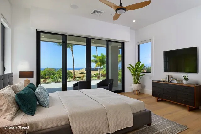 a bedroom with a bed potted plant and a large window