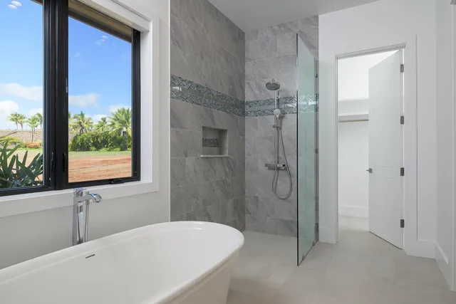 a bathroom with a tub shower and sink