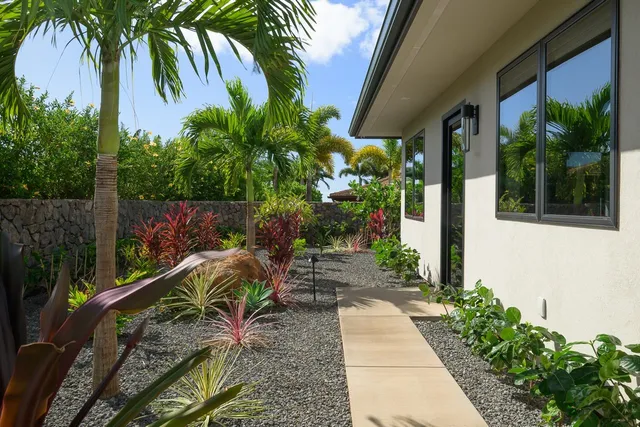 a large kitchen with kitchen island a large counter top a sink and a window