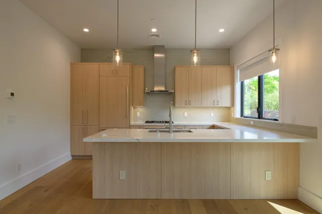 a kitchen with a stove a sink and a refrigerator