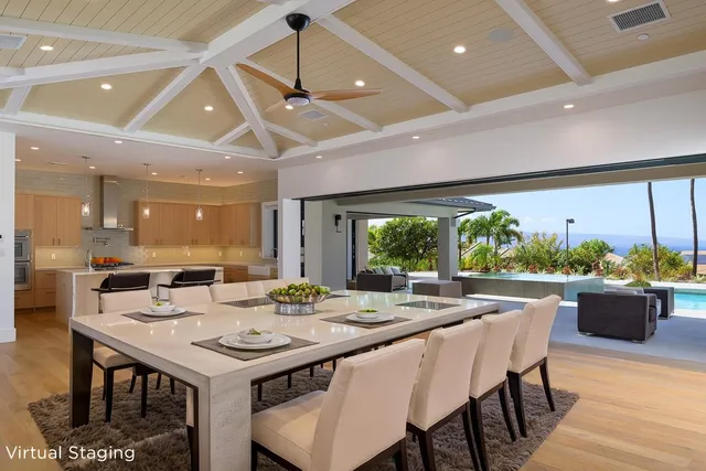 a dining room with furniture a rug and a floor to ceiling window