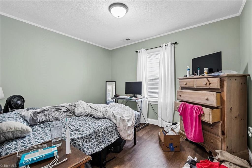 226 Friendly Avenue High Point, NC 27260 - Photo 25 of 38 The third bedroom includes its own window and desk space, ideal for a home office, tenant bedroom, or guest room.