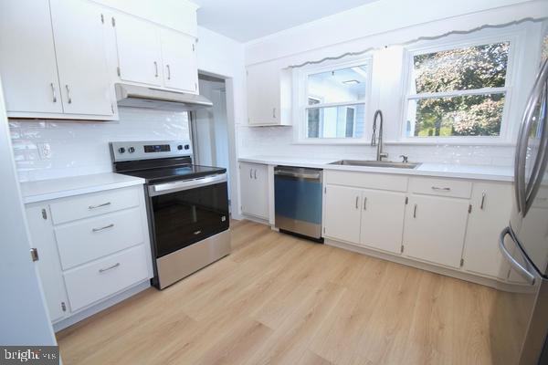 286 State Road West Grove, PA 19390 - Photo 11 of 53 a kitchen with granite countertop white cabinets stainless steel appliances a sink and a window