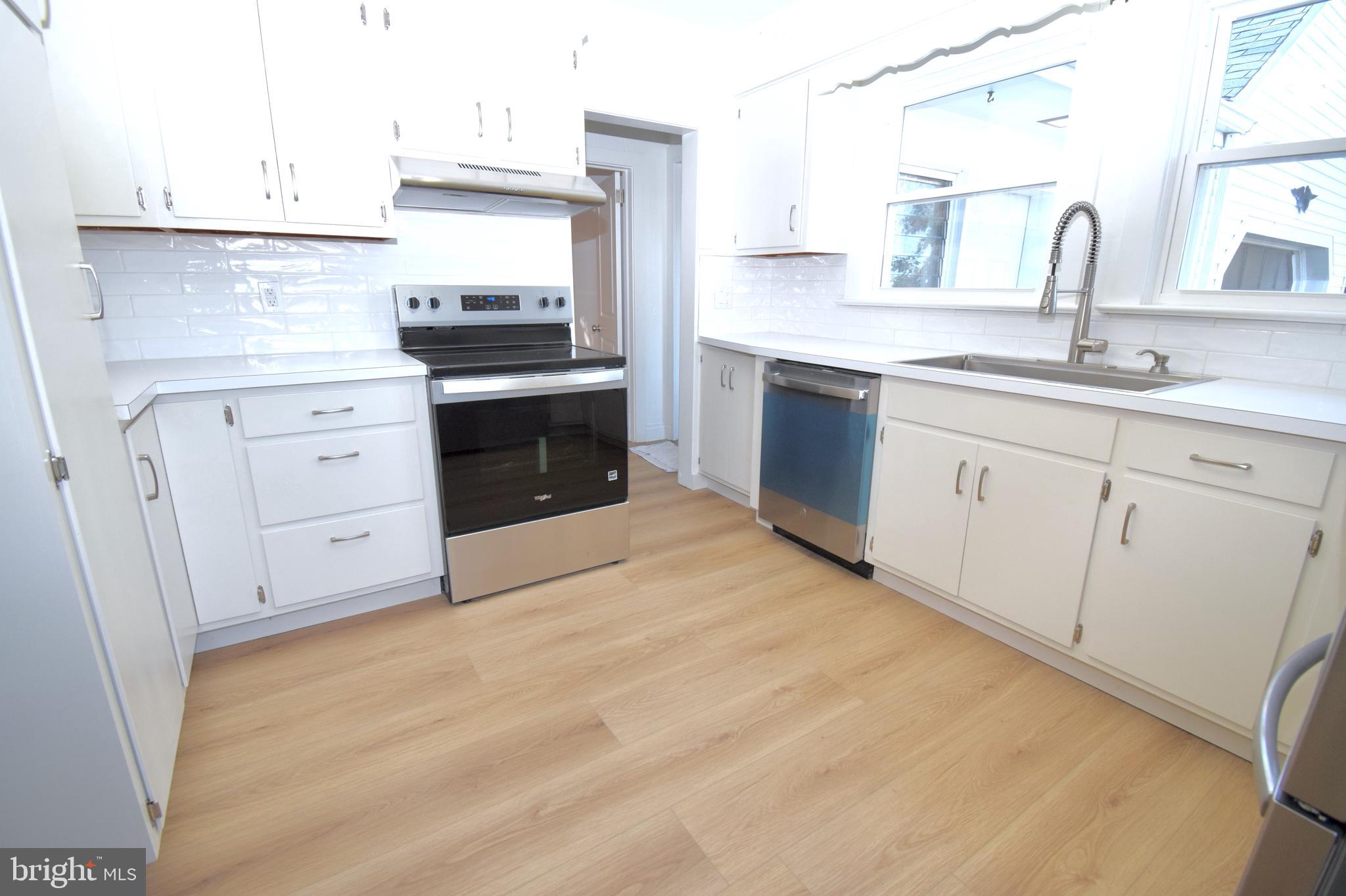 286 State Road West Grove, PA 19390 - Photo 12 of 53 a kitchen with white cabinets and appliances