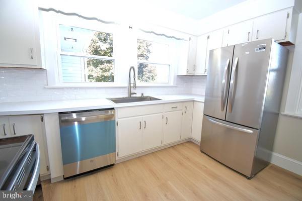 286 State Road West Grove, PA 19390 - Photo 14 of 53 a kitchen with stainless steel appliances a refrigerator sink and wooden floor