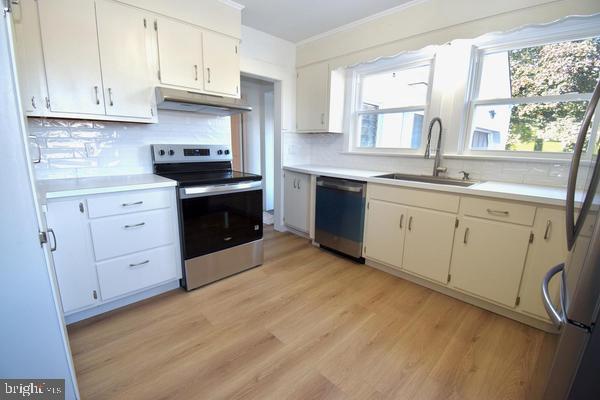 286 State Road West Grove, PA 19390 - Photo 15 of 53 a kitchen with granite countertop white cabinets sink and stainless steel appliances
