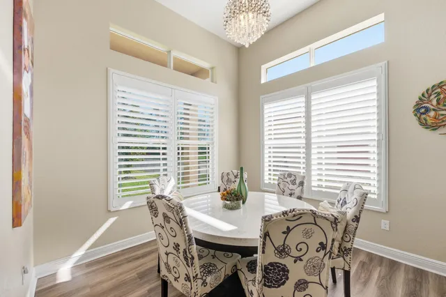 a dining hall with stainless steel appliances granite countertop a stove and a refrigerator