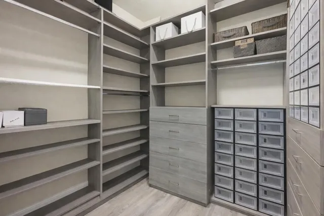 a spacious bathroom with a double vanity sink a large mirror and a bathtub