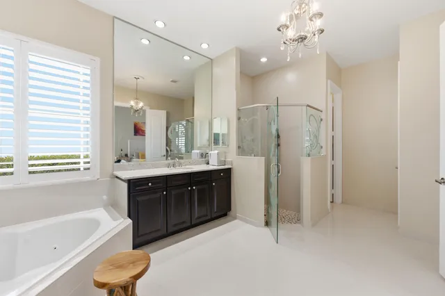 a bathroom with a granite countertop double vanity sink and a mirror