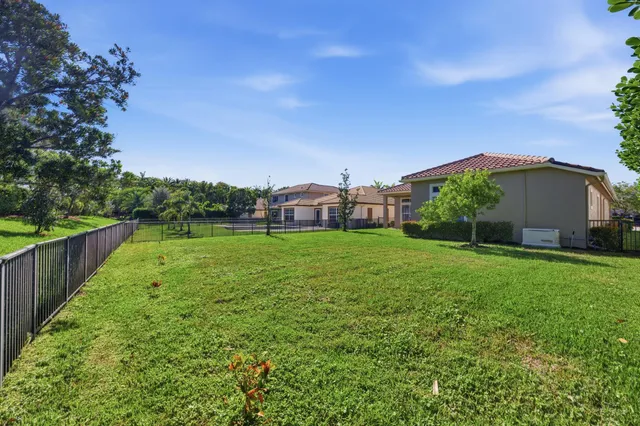 an aerial view of residential houses with outdoor space and swimming pool