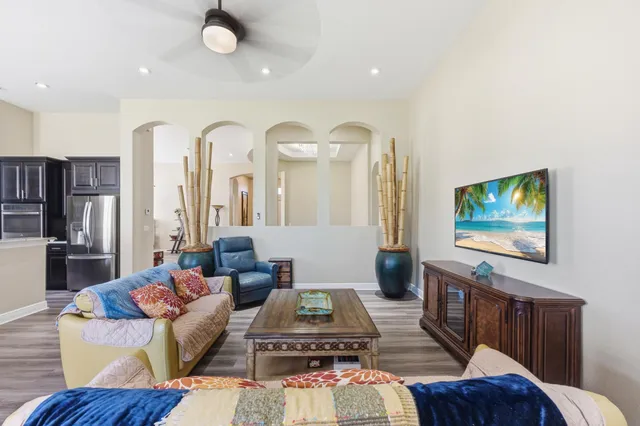 a living room with furniture and wooden floor