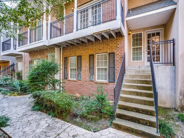 a front view of a residential apartment building with a yard