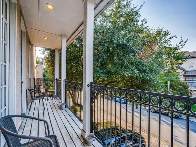 a view of balcony with floor to ceiling window and wooden fence