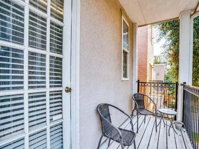 a view of a balcony with a couple of chairs