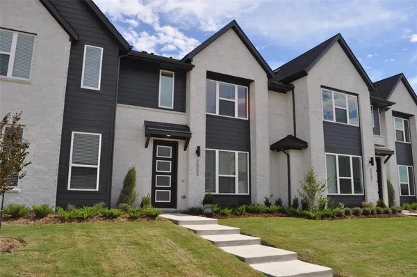 a front view of a house with a yard