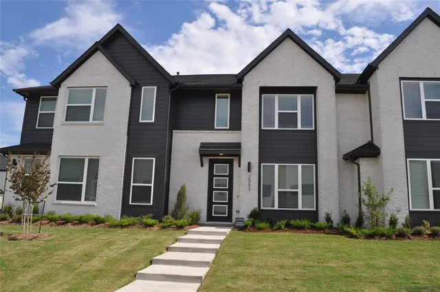 a front view of a house with a yard