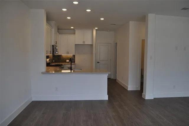 a room with wooden floor and furniture