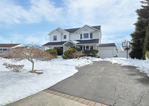 a view of a house with a snow on the road