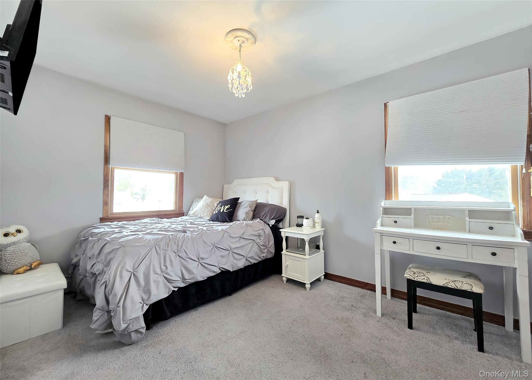 4 Cameo Road Commack, NY 11725 - Photo 12 of 23 a spacious bedroom with a bed and a chandelier