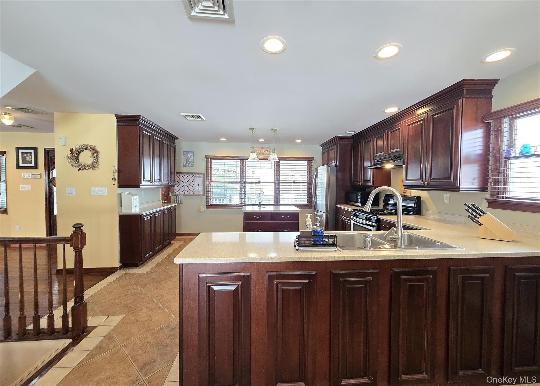 4 Cameo Road Commack, NY 11725 - Photo 4 of 23 a kitchen with sink refrigerator and cabinets