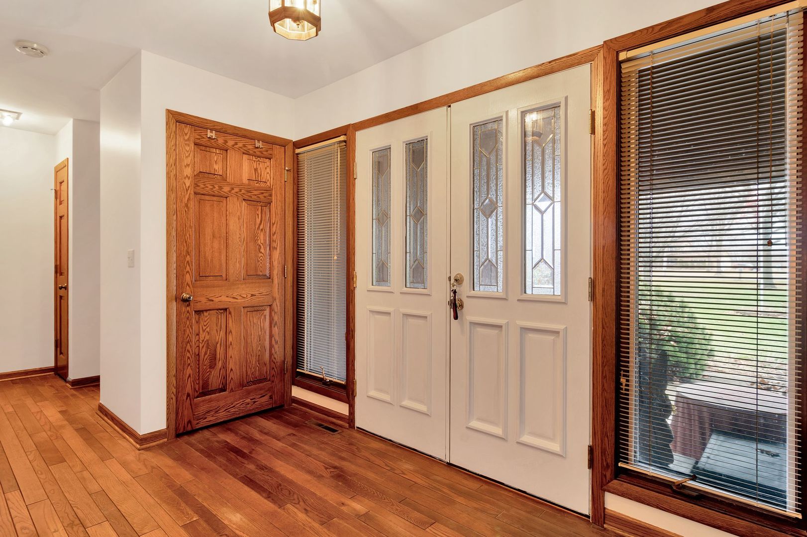3805 West Sandwich Road Sandwich, IL 60548 - Photo 5 of 28 a view of a hallway with wooden floor and closet area