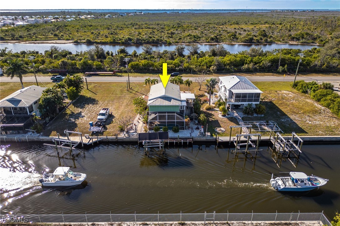 3374 York Road St. James City, FL 33956 - Photo 1 of 49 an aerial view of a house with a table chairs and umbrellas