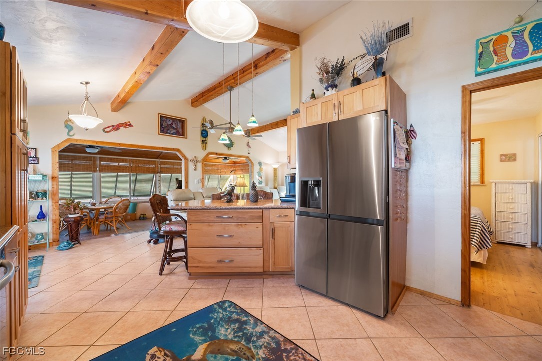 3374 York Road St. James City, FL 33956 - Photo 12 of 49 a kitchen with stainless steel appliances kitchen island granite countertop a refrigerator and a stove