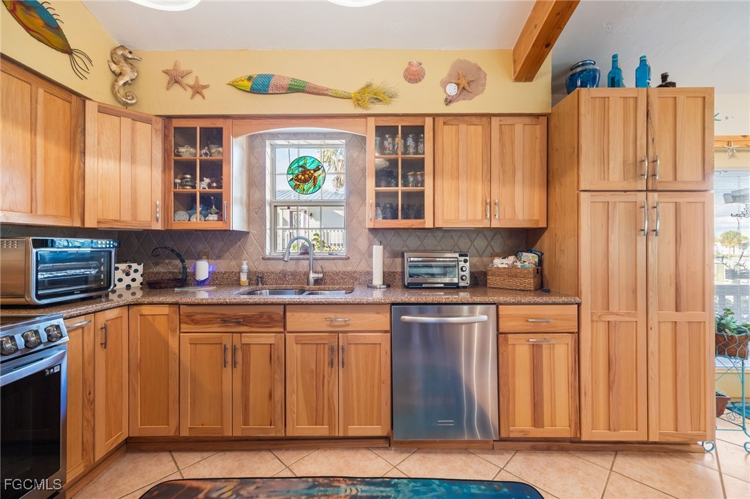 3374 York Road St. James City, FL 33956 - Photo 13 of 49 a kitchen with stainless steel appliances granite countertop a refrigerator and a stove top oven