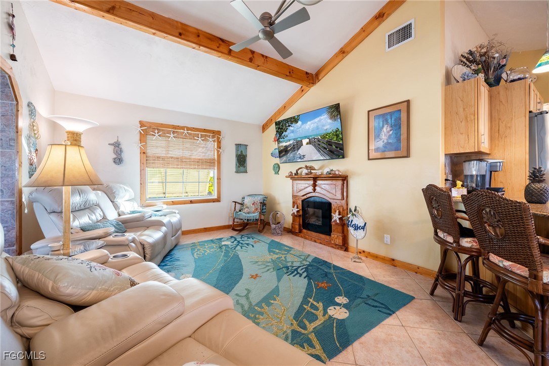 3374 York Road St. James City, FL 33956 - Photo 15 of 49 a living room with furniture fireplace and a large window