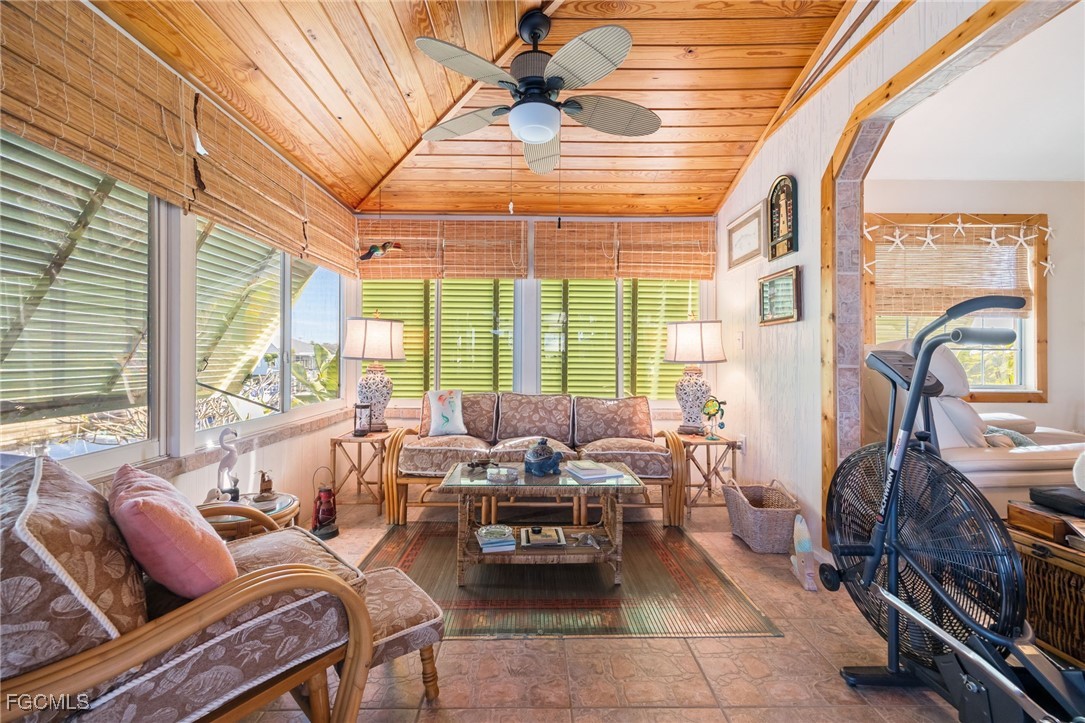 3374 York Road St. James City, FL 33956 - Photo 19 of 49 a living room with furniture and floor to ceiling windows