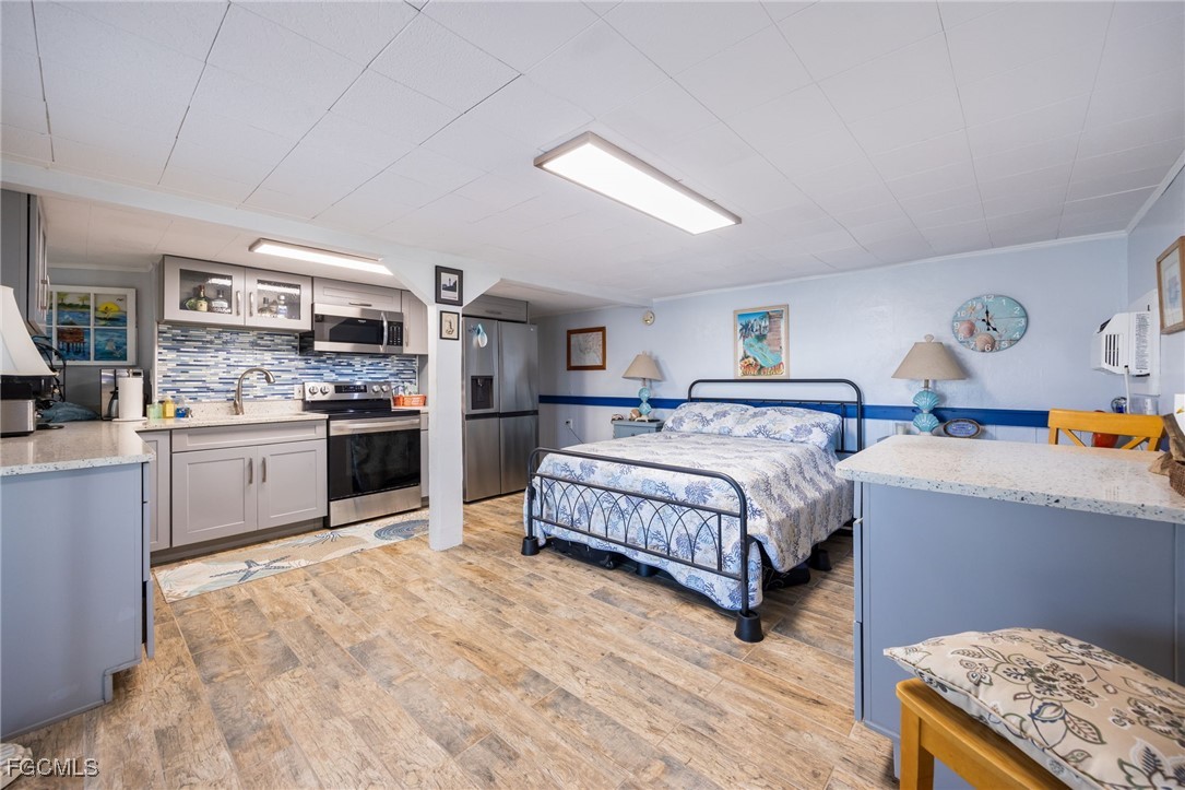 3374 York Road St. James City, FL 33956 - Photo 29 of 49 a spacious bedroom with a bed and cabinets