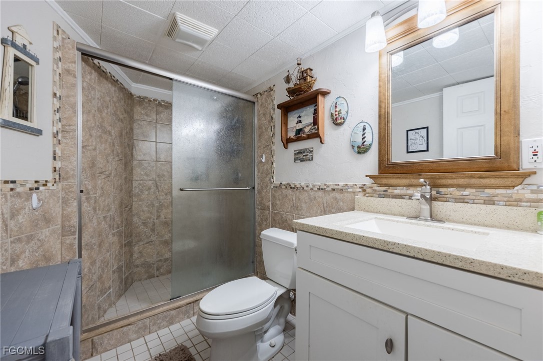 3374 York Road St. James City, FL 33956 - Photo 33 of 49 a bathroom with a sink toilet and shower