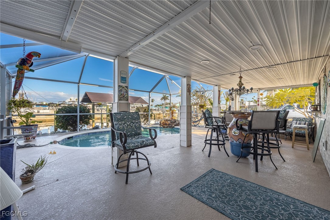 3374 York Road St. James City, FL 33956 - Photo 34 of 49 a view of a dining room with furniture wooden floor and chandelier