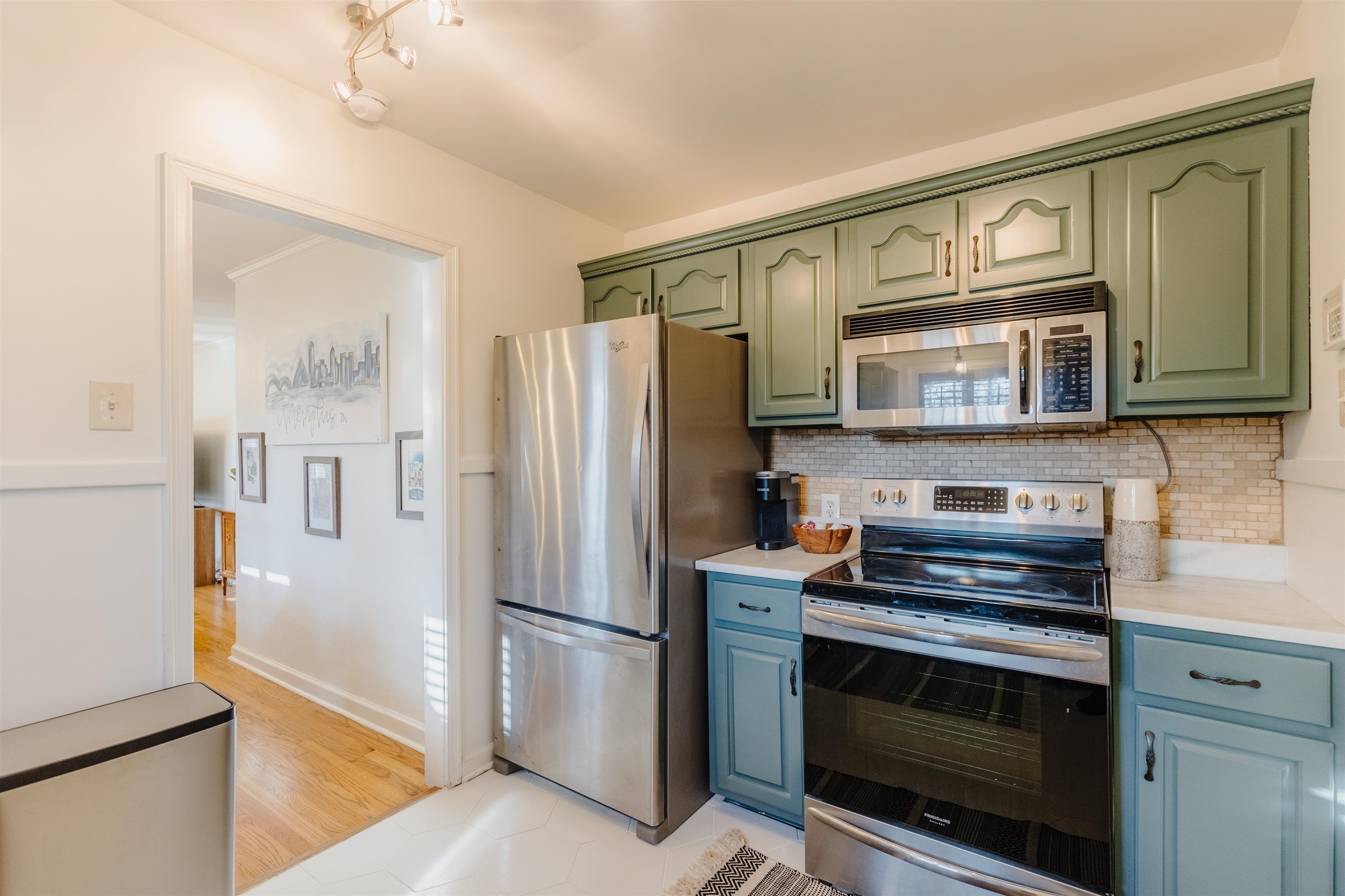 1247 Colonial Road Memphis, TN 38117 - Photo 7 of 29 a kitchen with stainless steel appliances granite countertop a refrigerator stove and microwave
