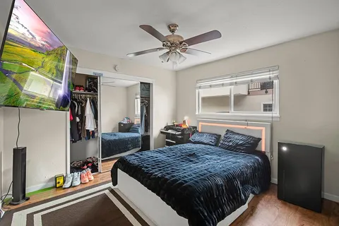 a bedroom with a bed and a window