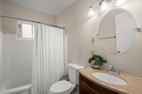 a bathroom with a sink toilet and mirror