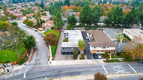 an aerial view of multiple houses with yard