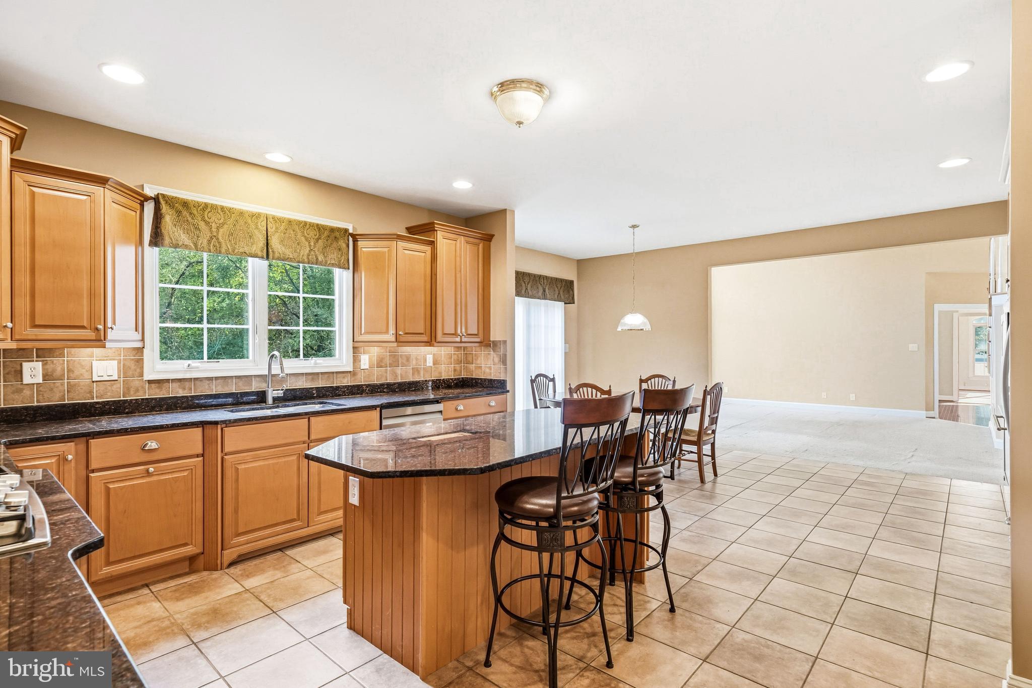 950 Borton Landing Road Moorestown, NJ 08057 - Photo 13 of 53 a dining hall with stainless steel appliances granite countertop a stove a sink a dining table and chairs
