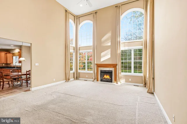 a view of a livingroom with a fireplace and large windows