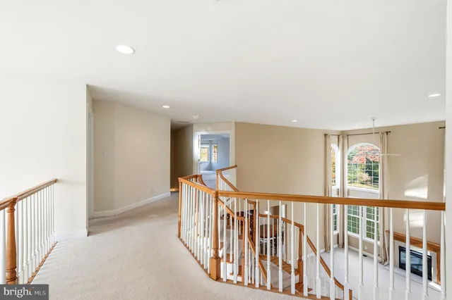 an empty room with a window and a ceiling fan
