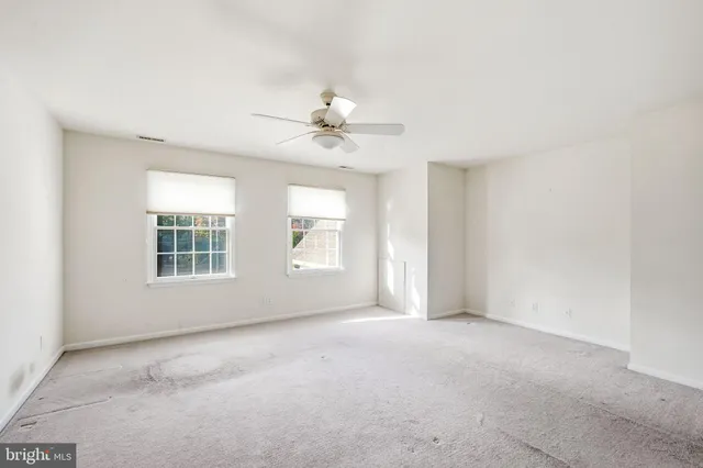 a bathroom with a toilet a sink a mirror a bathtub and vanity