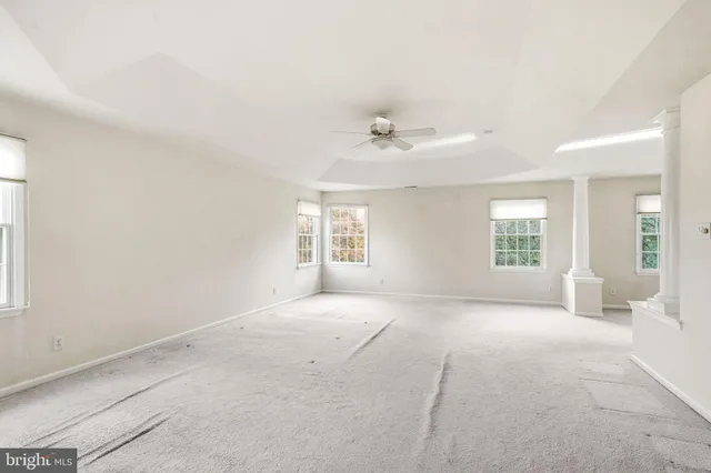 an empty room with windows and closet