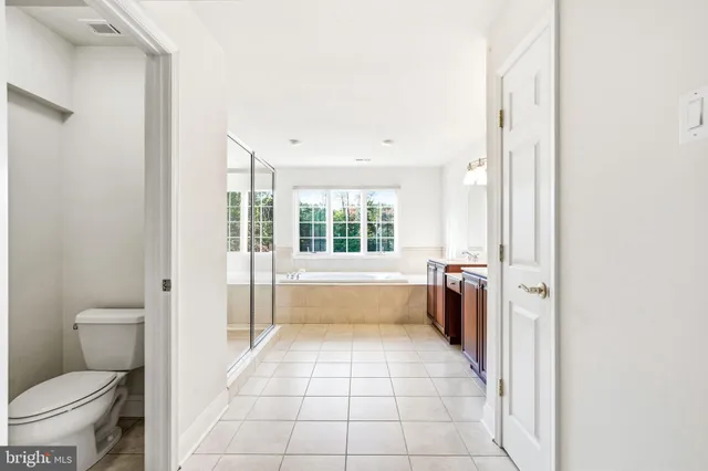 a large white kitchen with a large window