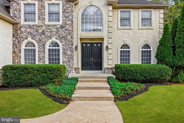 front view of a brick house with a yard