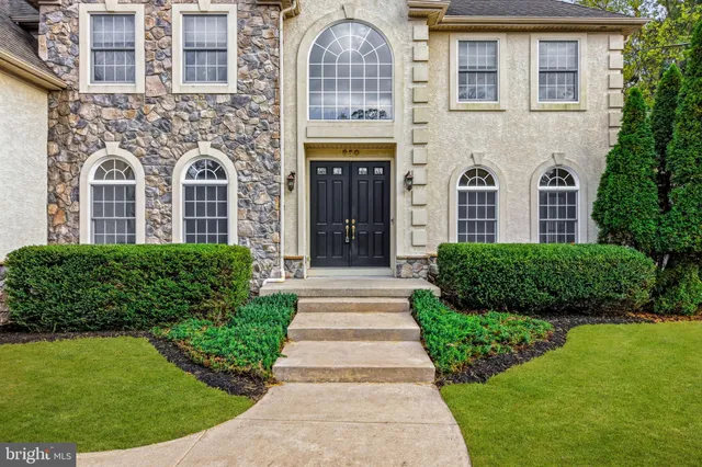 front view of a brick house with a yard