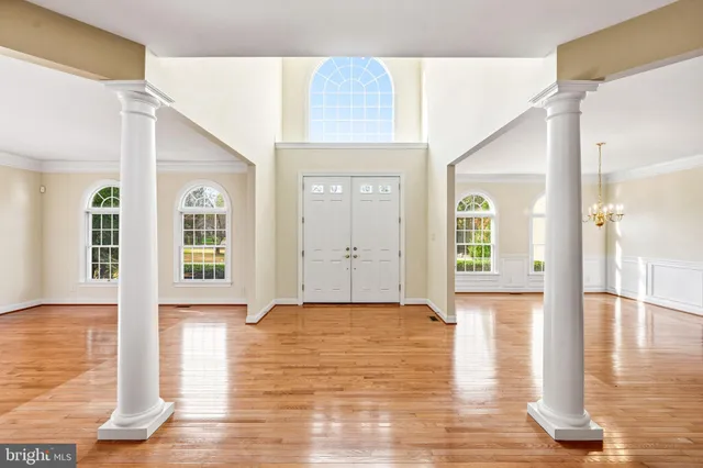 a kitchen with stainless steel appliances a dining table chairs and a refrigerator